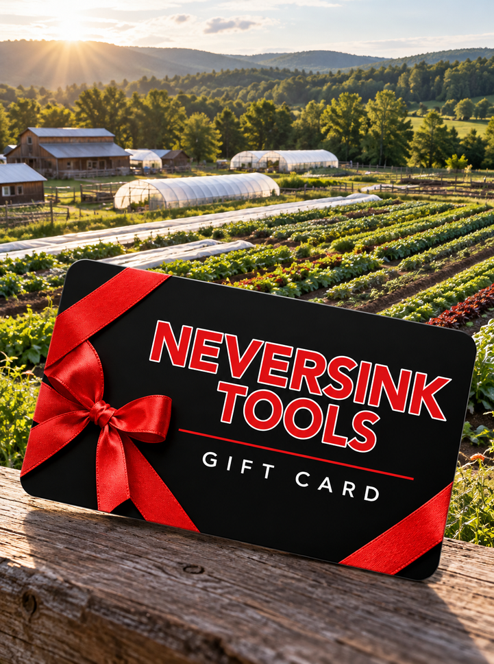 Neversink Tools gift card with a red ribbon and bow, tilted in front of a farm landscape